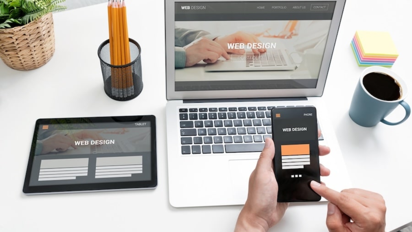 Web developer designs websites for different types of devices. Responsive web design concept